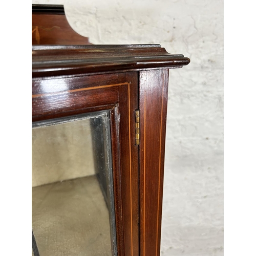 90 - An Edwardian inlaid mahogany display cabinet with single leaded glass door and tapering supports