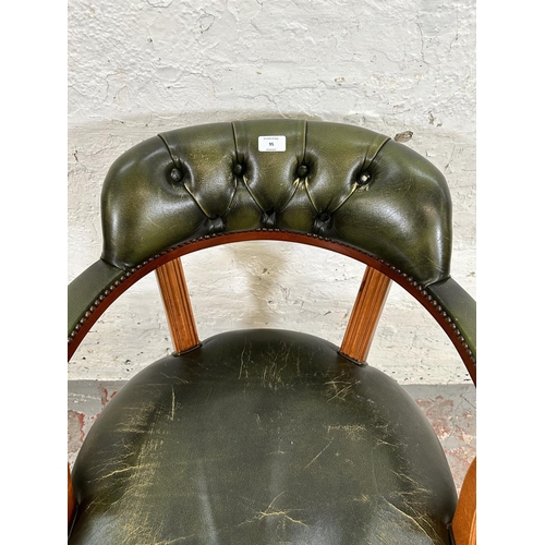 95 - A Regency style yew wood and green leatherette swivel desk chair