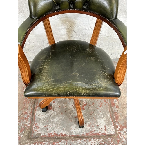 95 - A Regency style yew wood and green leatherette swivel desk chair