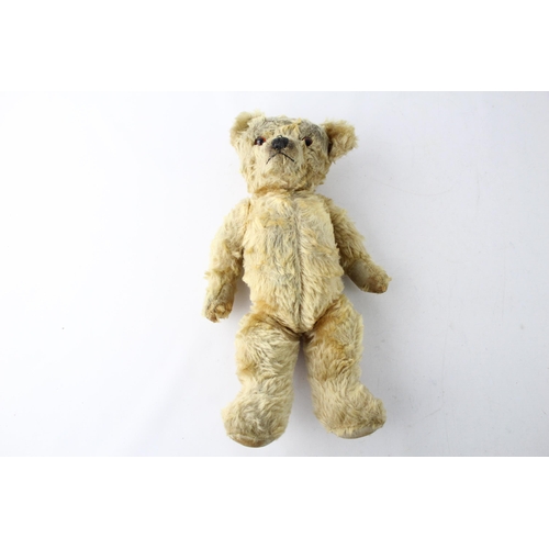 1699 - A vintage jointed teddy bear with glass eyes