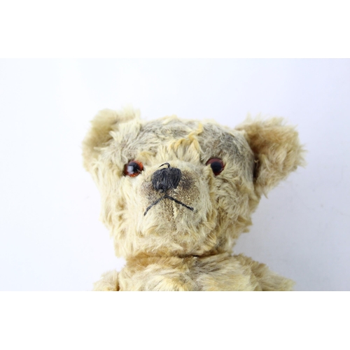 1699 - A vintage jointed teddy bear with glass eyes