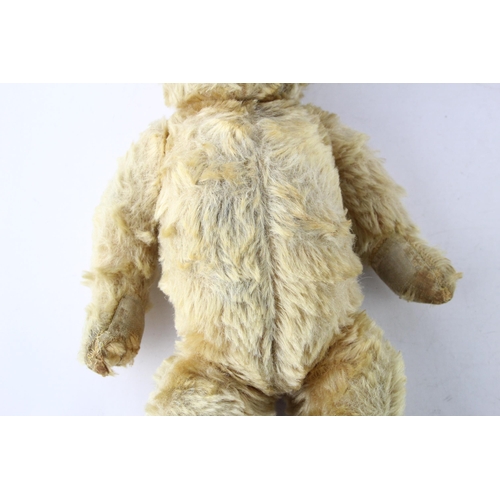 1699 - A vintage jointed teddy bear with glass eyes