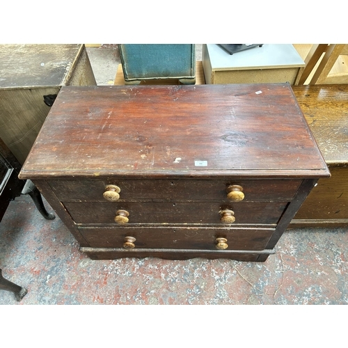 186 - A Victorian stained pine chest of three drawers