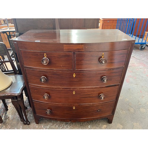 1 - A Georgian mahogany bow fronted chest of two short over three long drawers