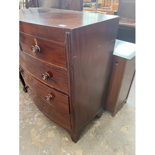 1 - A Georgian mahogany bow fronted chest of two short over three long drawers