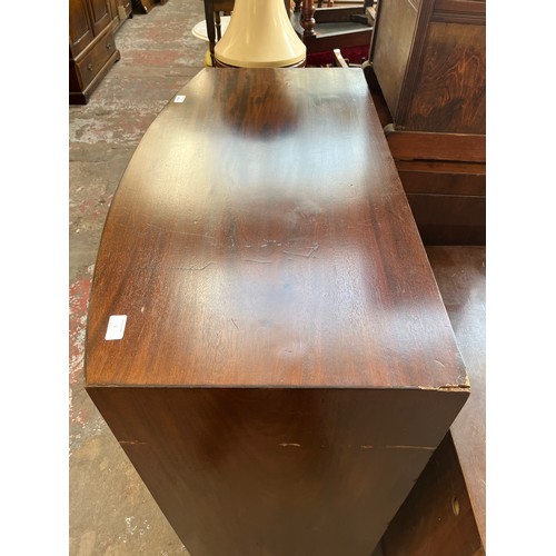 1 - A Georgian mahogany bow fronted chest of two short over three long drawers