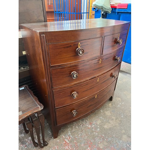 1 - A Georgian mahogany bow fronted chest of two short over three long drawers