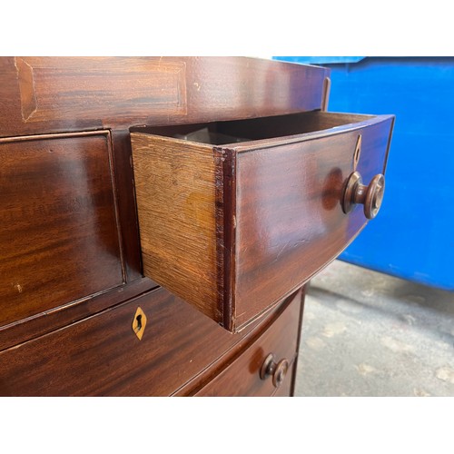 1 - A Georgian mahogany bow fronted chest of two short over three long drawers