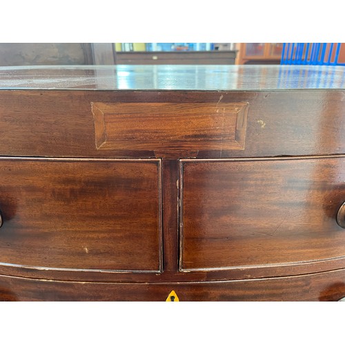 1 - A Georgian mahogany bow fronted chest of two short over three long drawers