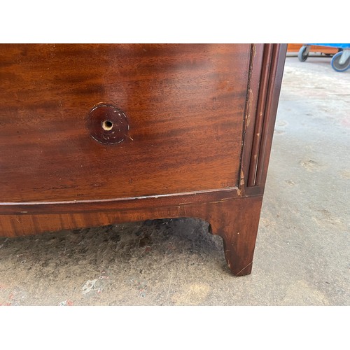 1 - A Georgian mahogany bow fronted chest of two short over three long drawers