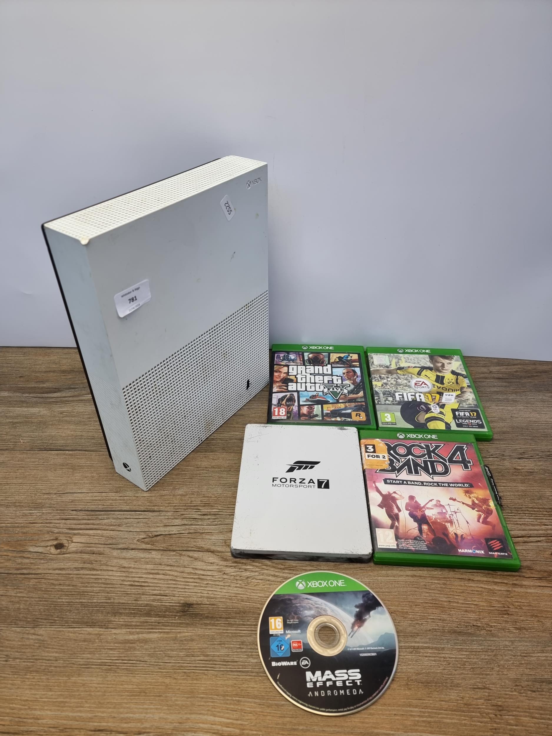 A Microsoft Xbox One S games console with five games