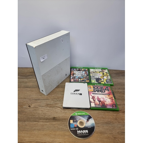 A Microsoft Xbox One S games console with five games