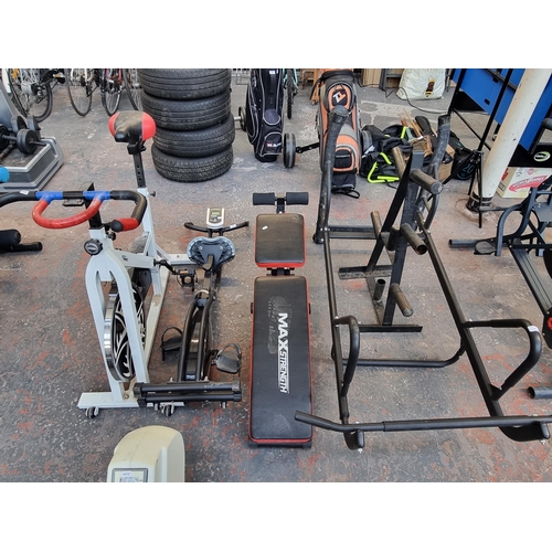 295 - Four pieces of fitness equipment, one Max Strength bench, one Roger Black folding exercise bike, one... 