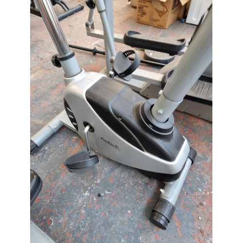 301 - A collection of exercise equipment to include V-Fit rowing machine, black metal barbell, Reebok cros... 