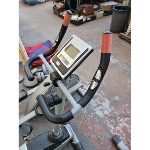 301 - A collection of exercise equipment to include V-Fit rowing machine, black metal barbell, Reebok cros... 