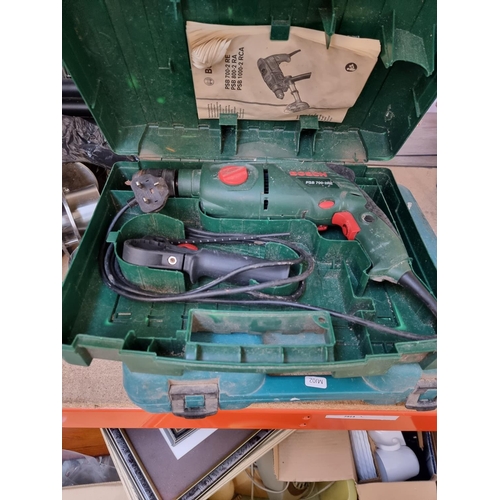 333 - Three cased power drills, one Makita with battery and charger, one Bosch 240v and one Performance Pr... 