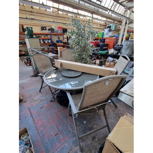 376 - A six piece garden dining set comprising four chairs, boxed parasol and circular table