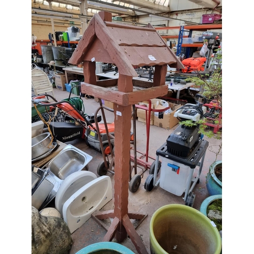 393 - A wooden bird feeder on pedestal base - approx. 157cm high