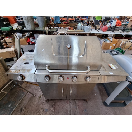 398 - A B&Q Seattle four burner gas barbeque with side burner