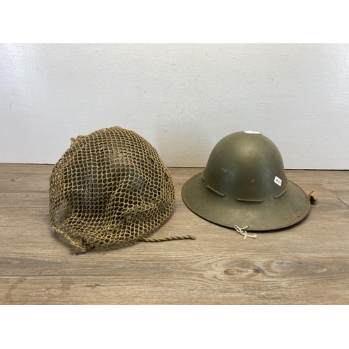 1259 - Two military helmets, one WWII Zuckerman and one plastic with German painted flag