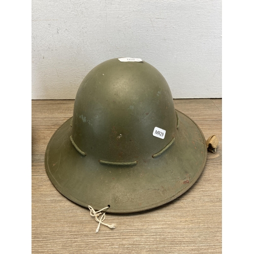 1259 - Two military helmets, one WWII Zuckerman and one plastic with German painted flag