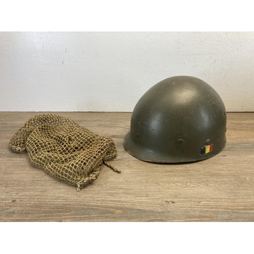 1259 - Two military helmets, one WWII Zuckerman and one plastic with German painted flag