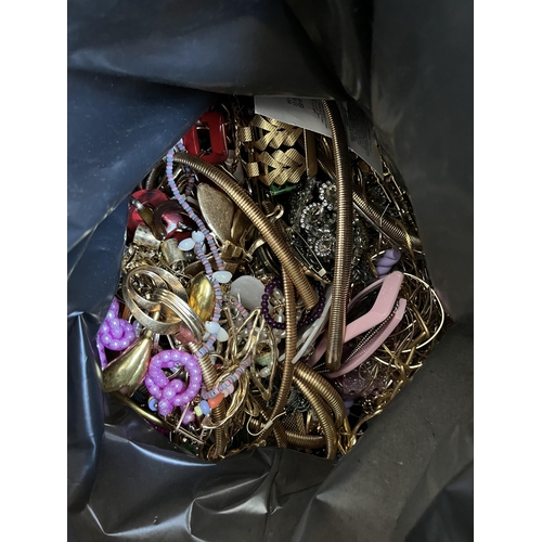 421 - A bag containing a large quantity of costume jewellery