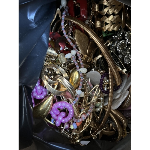 421 - A bag containing a large quantity of costume jewellery