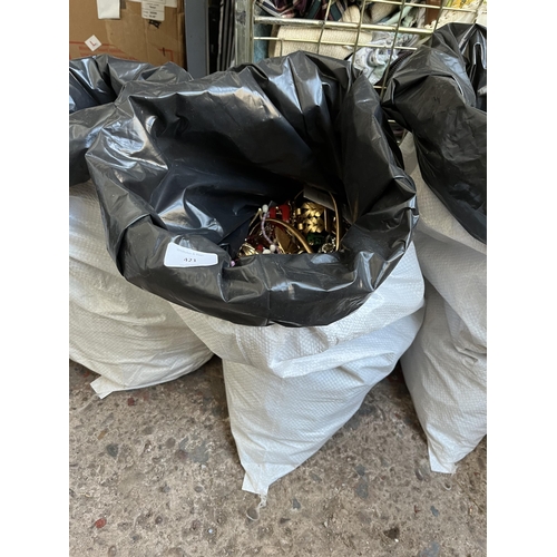 421 - A bag containing a large quantity of costume jewellery