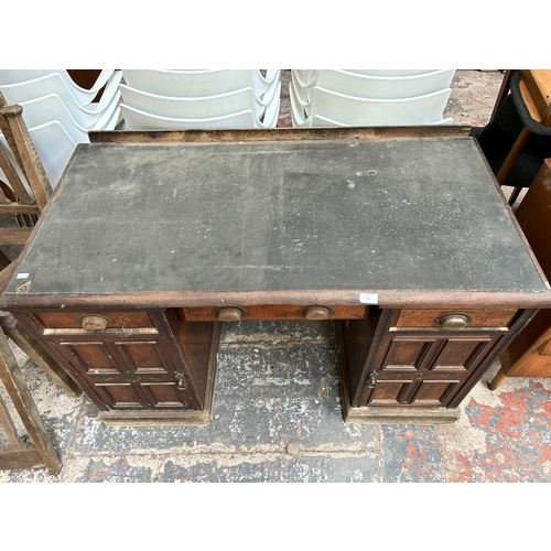 43 - A Victorian mahogany pedestal desk with black leather writing surface, three drawers and two cupboar... 