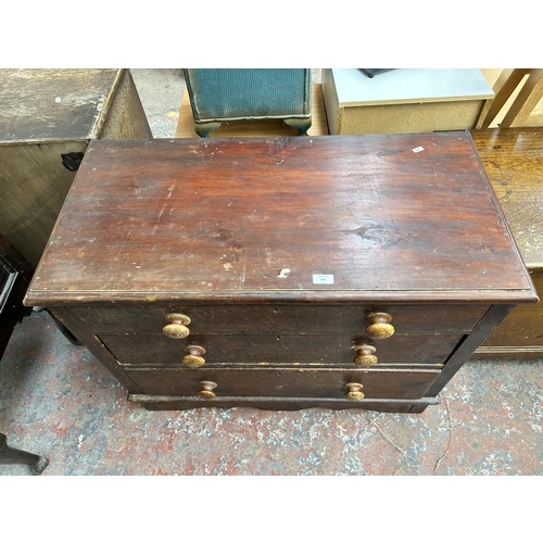 186 - A Victorian stained pine chest of three drawers