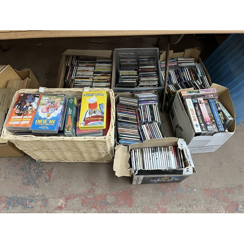 400 - Seven boxes containing a large quantity of CDs and VHS tapes