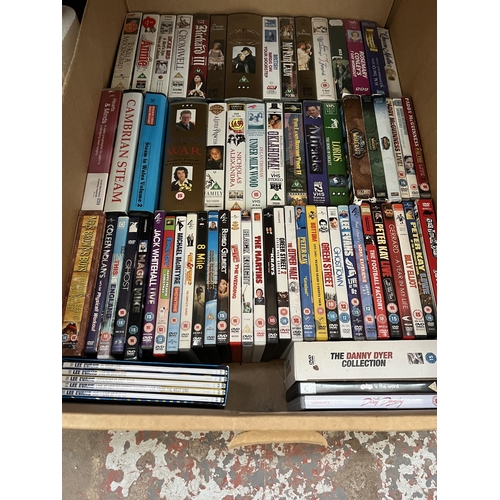 411 - Twelve boxes containing a large quantity of DVDs, CDs and VHS tapes