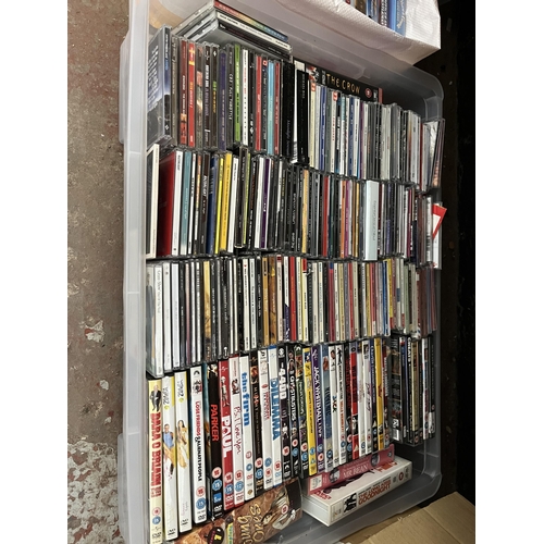 411 - Twelve boxes containing a large quantity of DVDs, CDs and VHS tapes