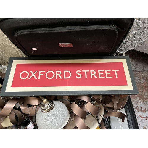 409 - Three suitcases and one laundry basket containing Oxford Street canvas print, black metal folding sa... 