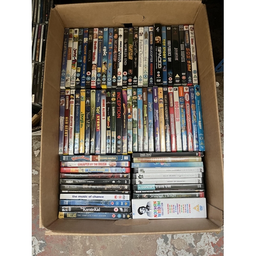 411 - Twelve boxes containing a large quantity of DVDs, CDs and VHS tapes