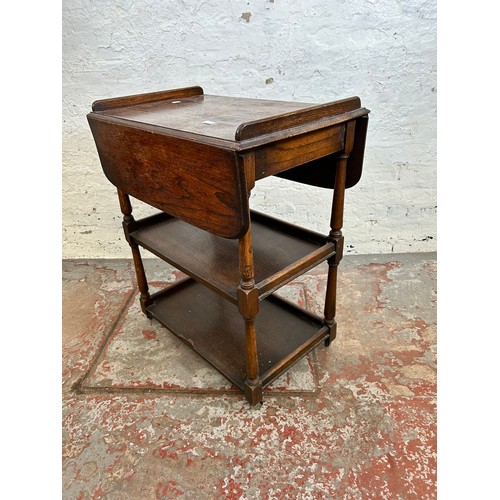 168 - A mid 20th century oak drop leaf three tier tea trolley