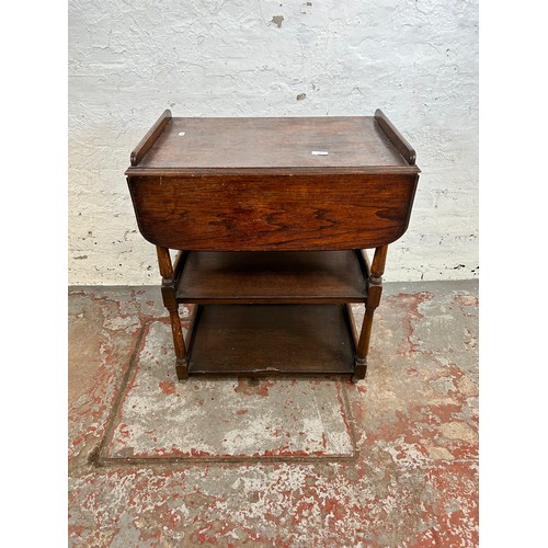 168 - A mid 20th century oak drop leaf three tier tea trolley