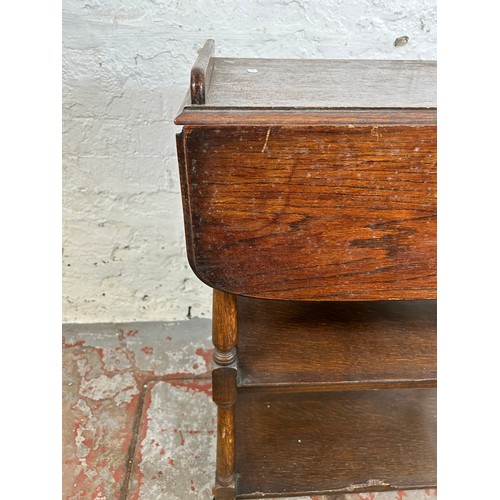 168 - A mid 20th century oak drop leaf three tier tea trolley