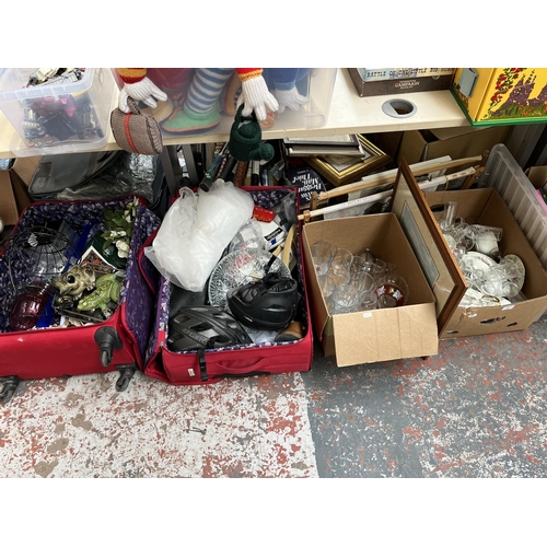 437 - Two boxes and two suitcases containing glassware, ceramics, cycling helmets etc.