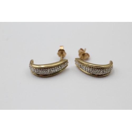 1010 - Two pairs of 9ct white and yellow gold diamond half hoop earrings - approx. gross weight 4.3 grams