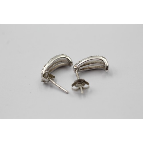 1010 - Two pairs of 9ct white and yellow gold diamond half hoop earrings - approx. gross weight 4.3 grams