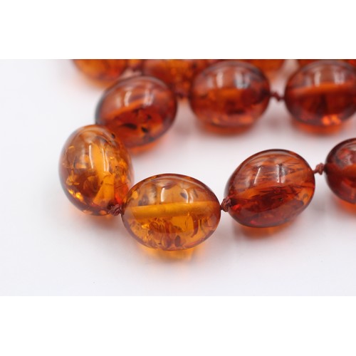 1019 - An amber beaded single strand necklace with 9ct gold clasp - approx. gross weight 40.5 grams