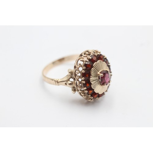 1022 - A 9ct gold garnet oval halo ring - approx. gross weight 4 grams