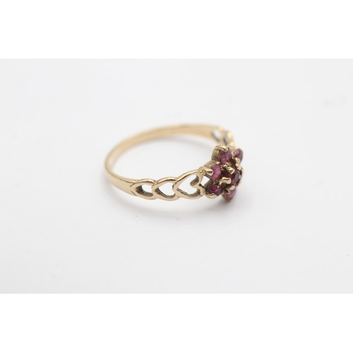 1027 - A 9ct gold ruby floral cluster ring with heart openwork shank - approx. gross weight 1.2 grams