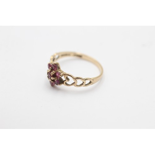 1027 - A 9ct gold ruby floral cluster ring with heart openwork shank - approx. gross weight 1.2 grams