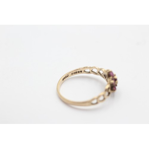 1027 - A 9ct gold ruby floral cluster ring with heart openwork shank - approx. gross weight 1.2 grams