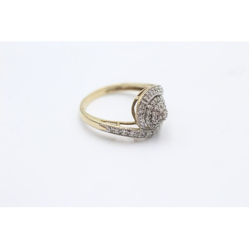 1032 - A 9ct gold diamond twist halo ring - approx. gross weight 2.5 grams