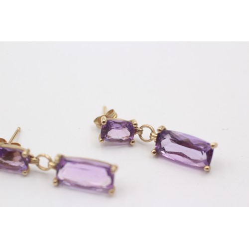 1034 - A pair of 9ct gold amethyst drop earrings - approx. gross weight 2.4 grams