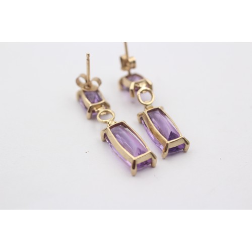 1034 - A pair of 9ct gold amethyst drop earrings - approx. gross weight 2.4 grams